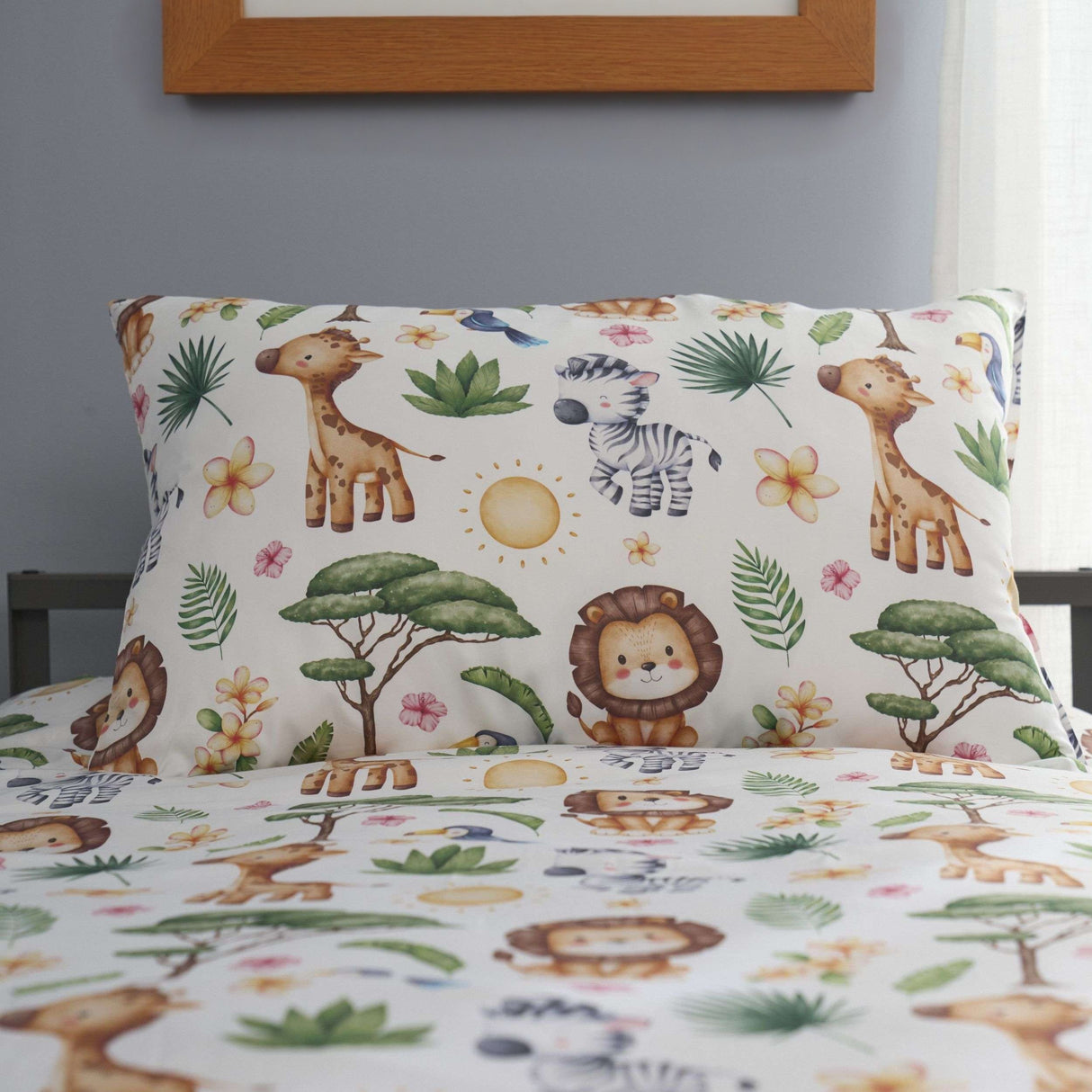 Children's bedding set with safari-themed design featuring animals and plants on a bed.