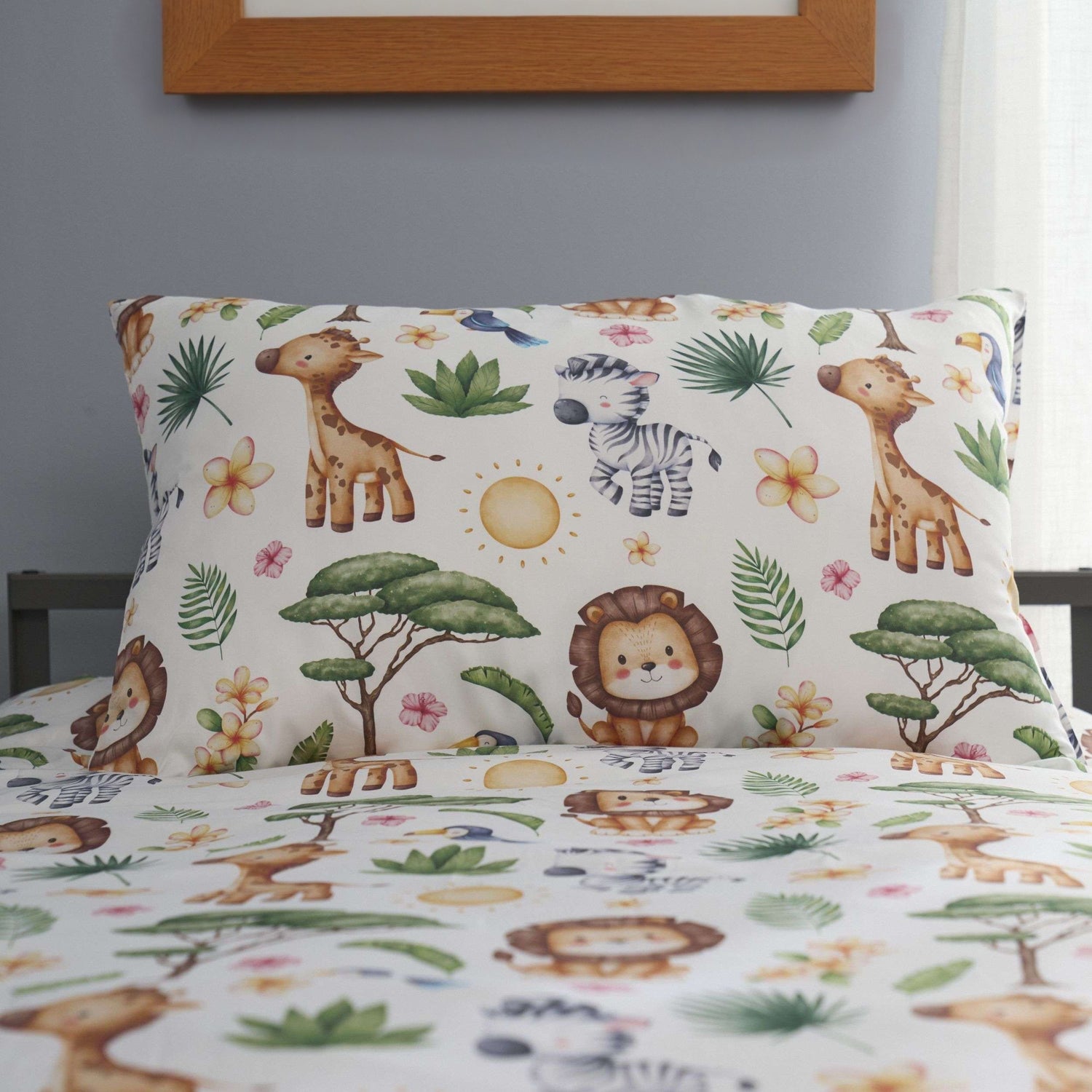 Children's bedding set with safari-themed design featuring animals and plants on a bed.