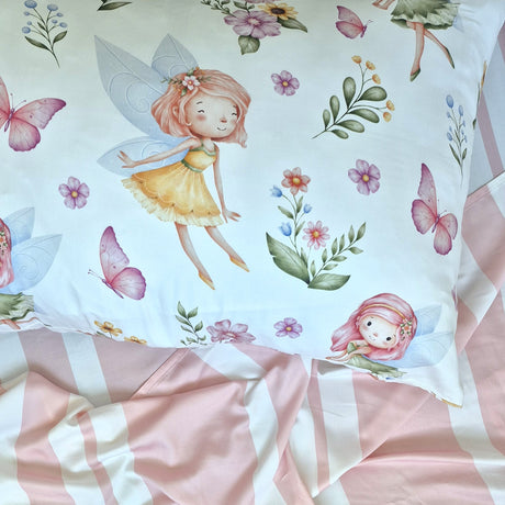 Fabric with fairy and floral pattern, featuring pink and green colors.