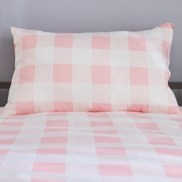 Pink and white checkered bedding set on a bed with a gray background