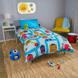 Children's bedroom with colorful bedding featuring vehicles and toys on the floor.