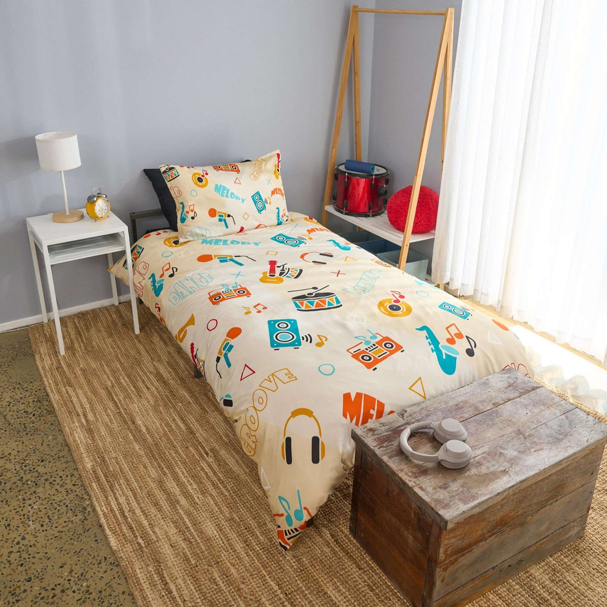 Children's bedroom with a bed featuring musical-themed bedding
