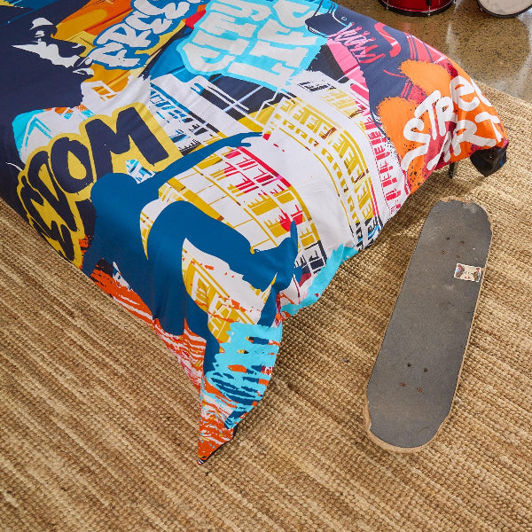 Colorful skateboard deck withcolourful street design on a carpeted floor