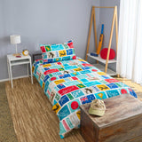 Colorful cricket themed bedding set on a bed in a room with a lamp, clock, and sports equipment.