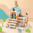 Toy set with a small house, animals, and people figures on a colorful background