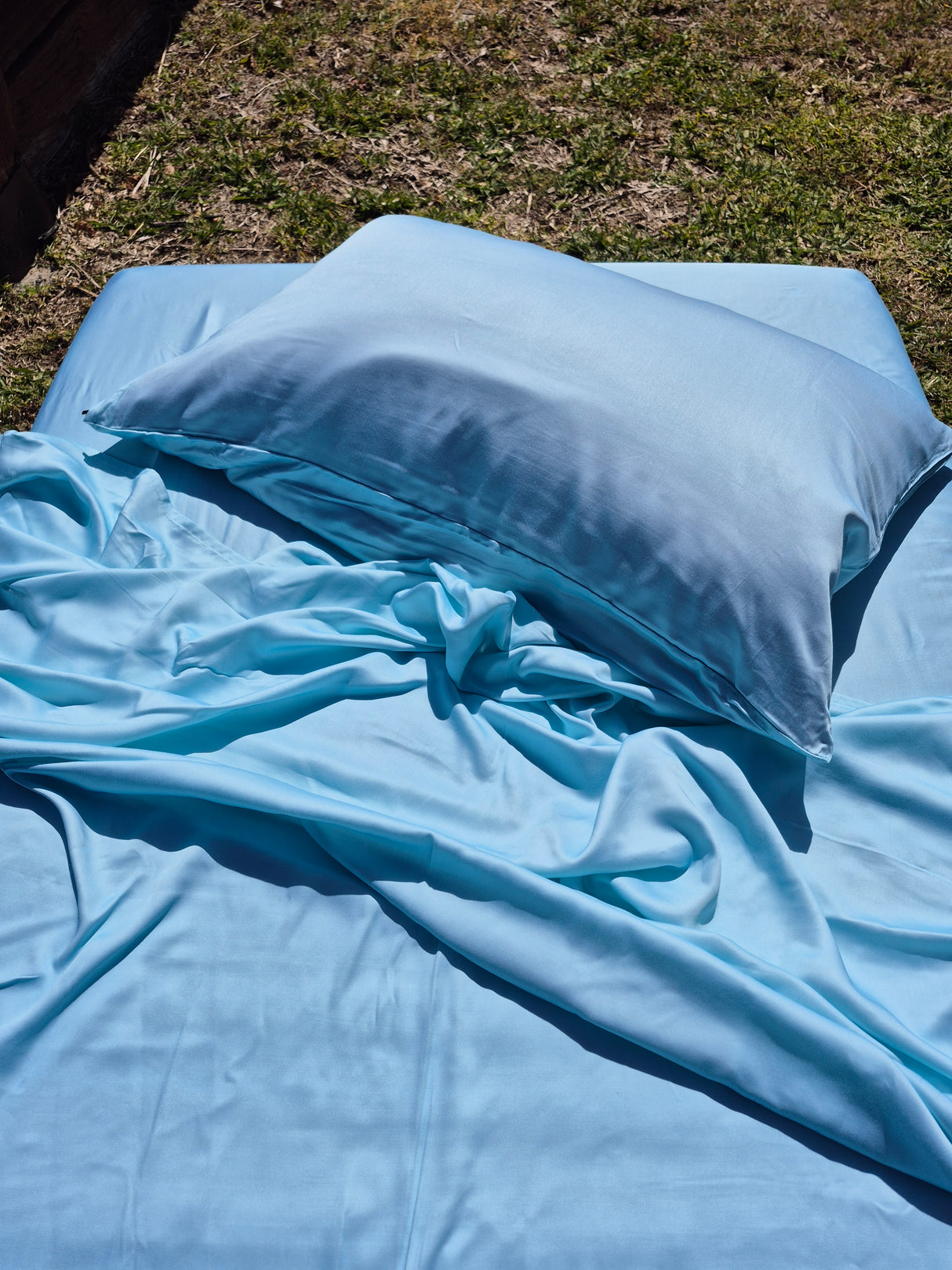Caribbean blue bedding set on a grassy surface