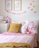 Children's bedroom with pink bedding, yellow pillow, and octopus european pillow