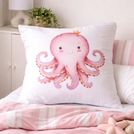 Decorative pillow with a pink octopus design on a bed with pink bedding.