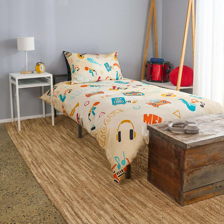 Bedroom with retro style, colourful bedding featuring musical instruments, nightstand, and lamp.