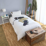 Bedroom with a bed featuring a skateboarder, wooden nightstand, and skateboard on a shelf.