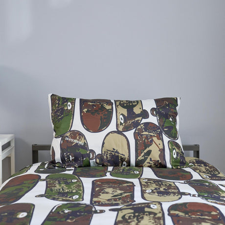 Camouflage-coloured skateboards on a bedding set on a bed with a plain background