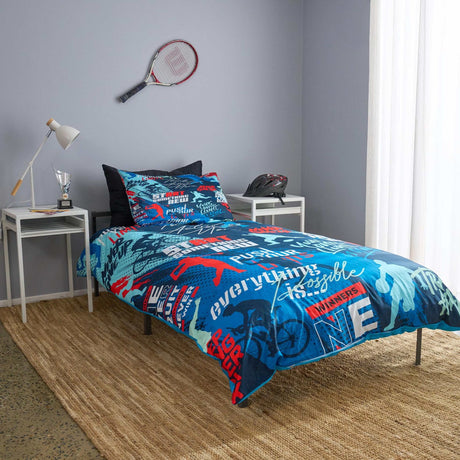 Bedroom with blue and red spots themed bedding set on a bed, tennis racket and helmet on shelves.
