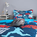 Bicycle helmet on a bed with sports-themed bedding and pillows.