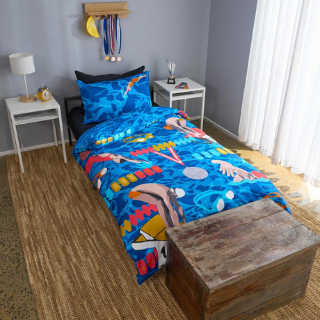 Bedroom with blue bedding featuring colorful swimmer design, wooden nightstands, and a lamp.