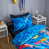 Bedding set with blue water design featuring swimmer graphics in a bedroom setting.